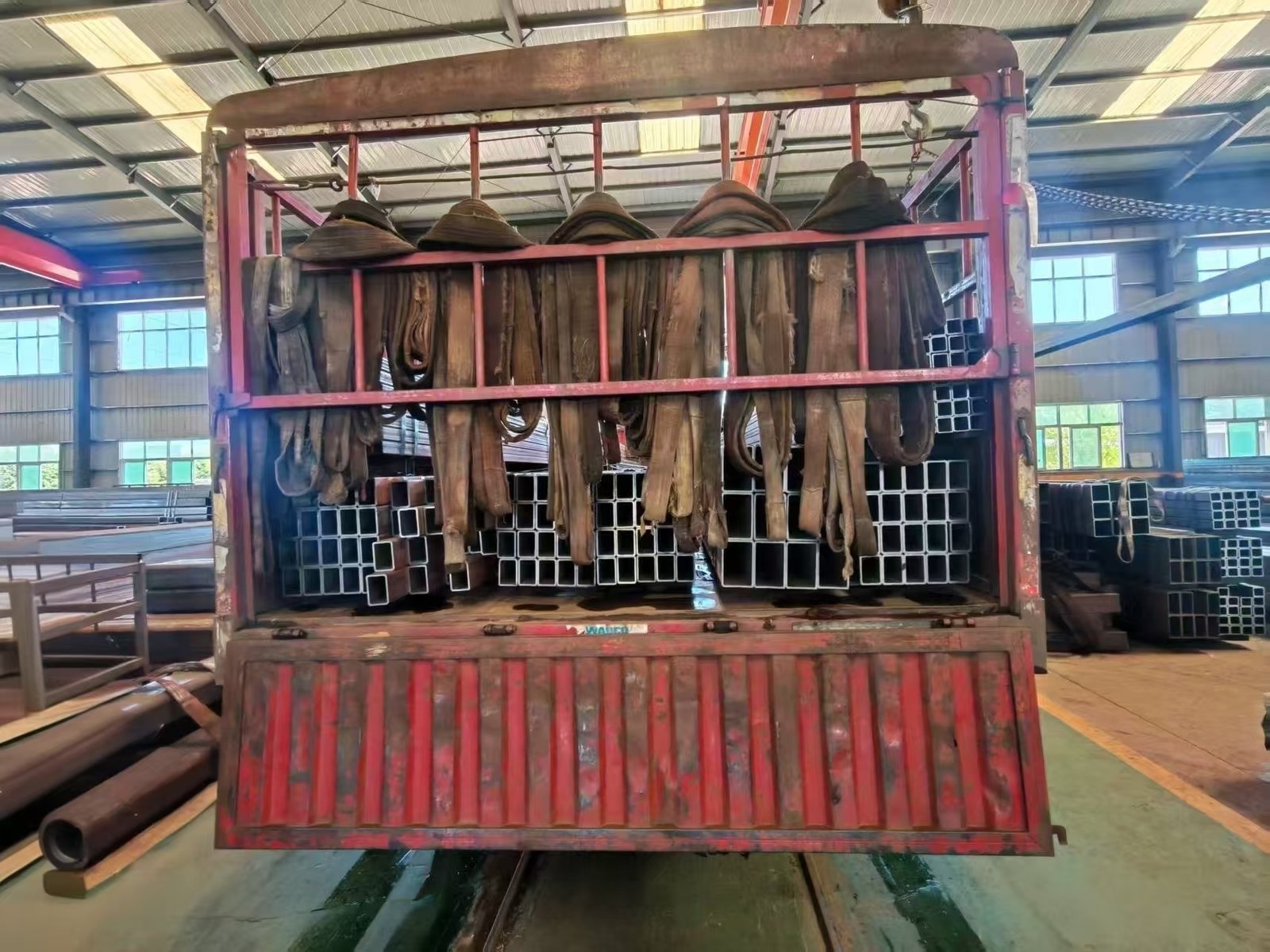 Trucks loaded with steel bundles leaving the factory for the port of Qingdao