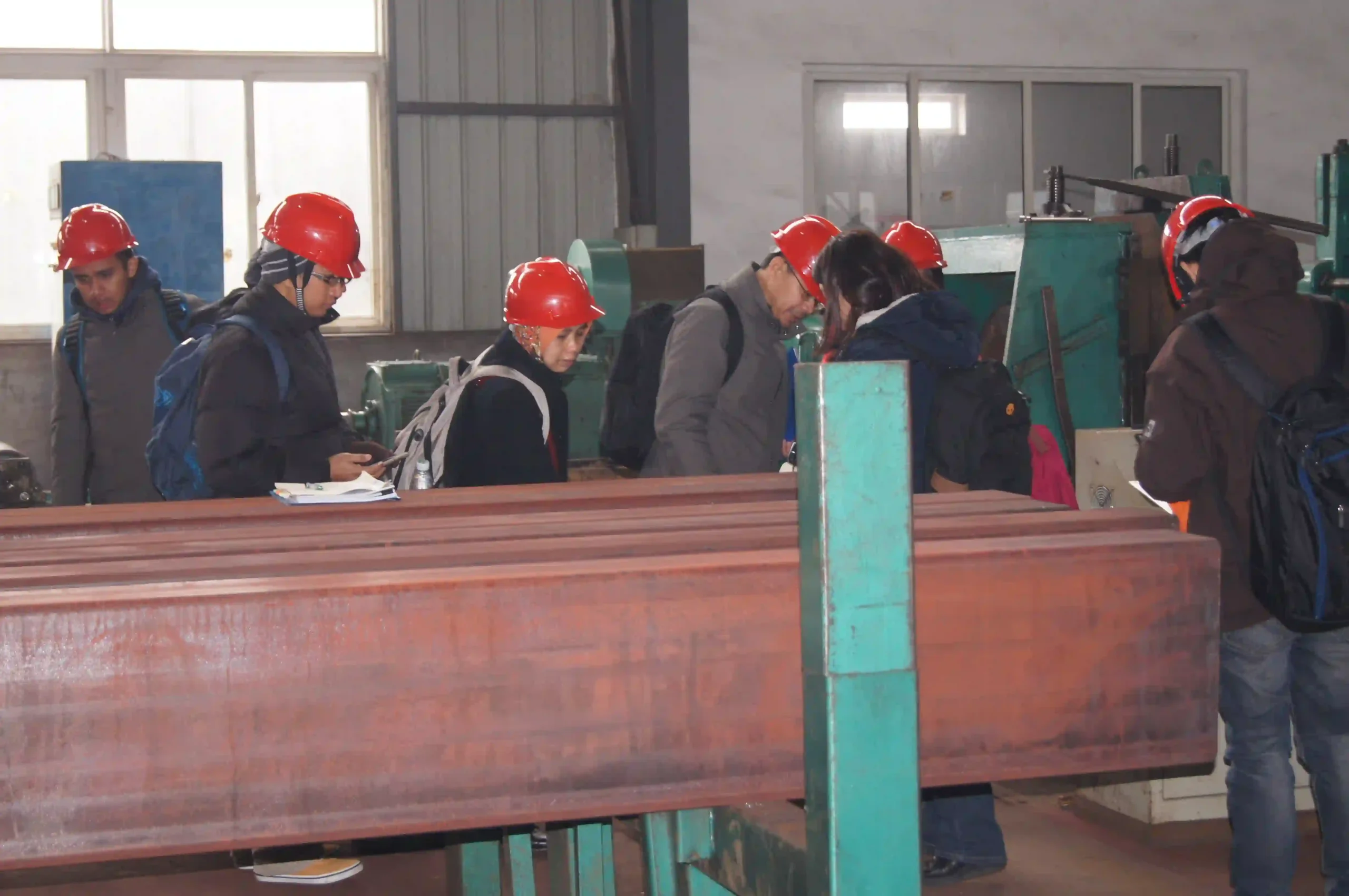 Client and QC staff verifying steel tube surface and packing before shipment