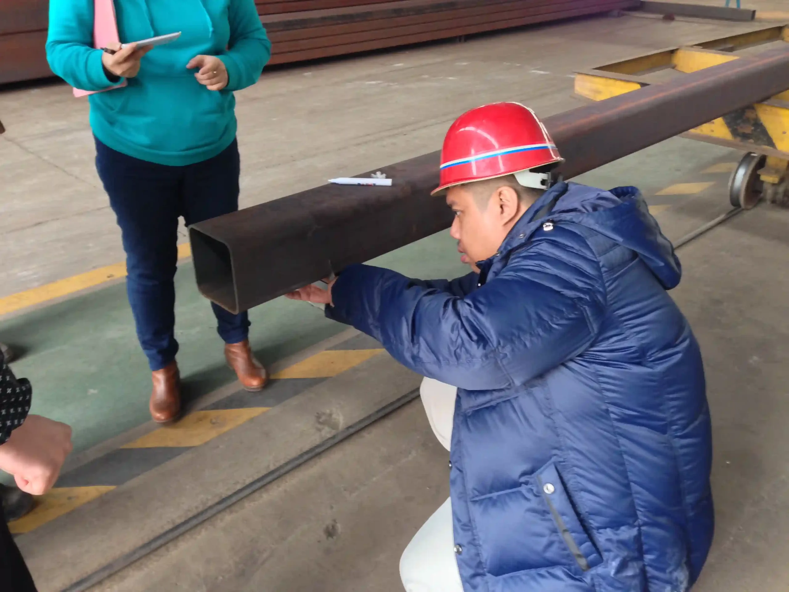 Client measuring wall thickness of steel tubes during pre-shipment inspection