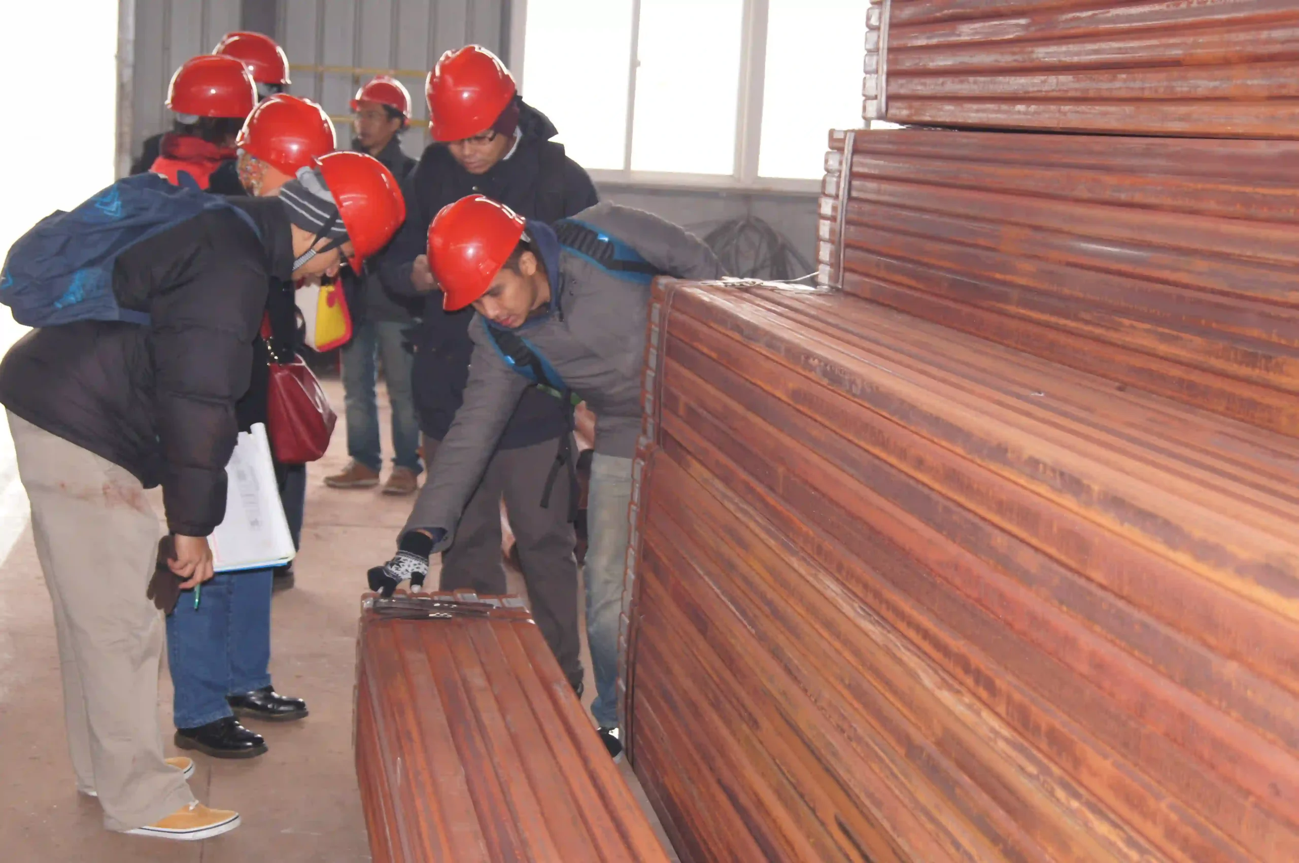 Overseas buyer inspecting steel tube goods before shipment