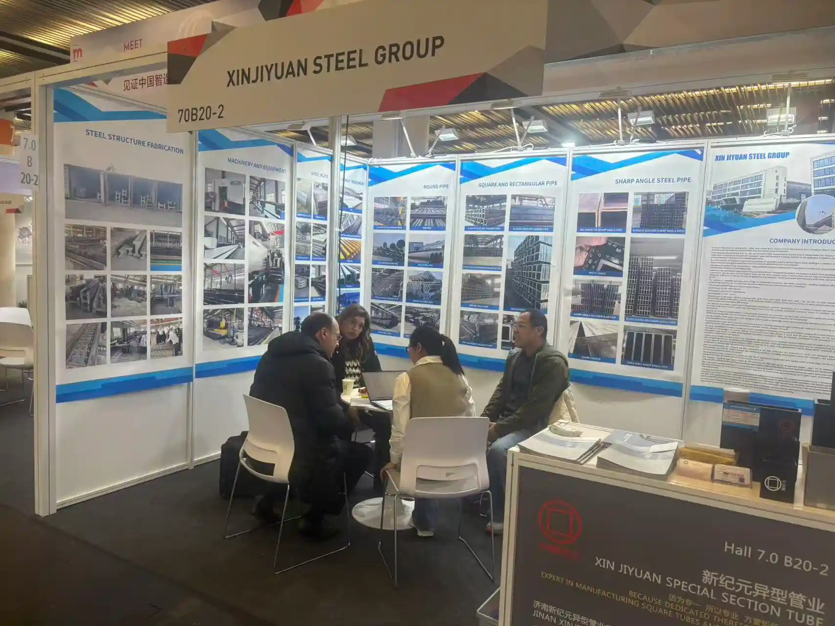Export team presenting steel specifications to visitors at the fair