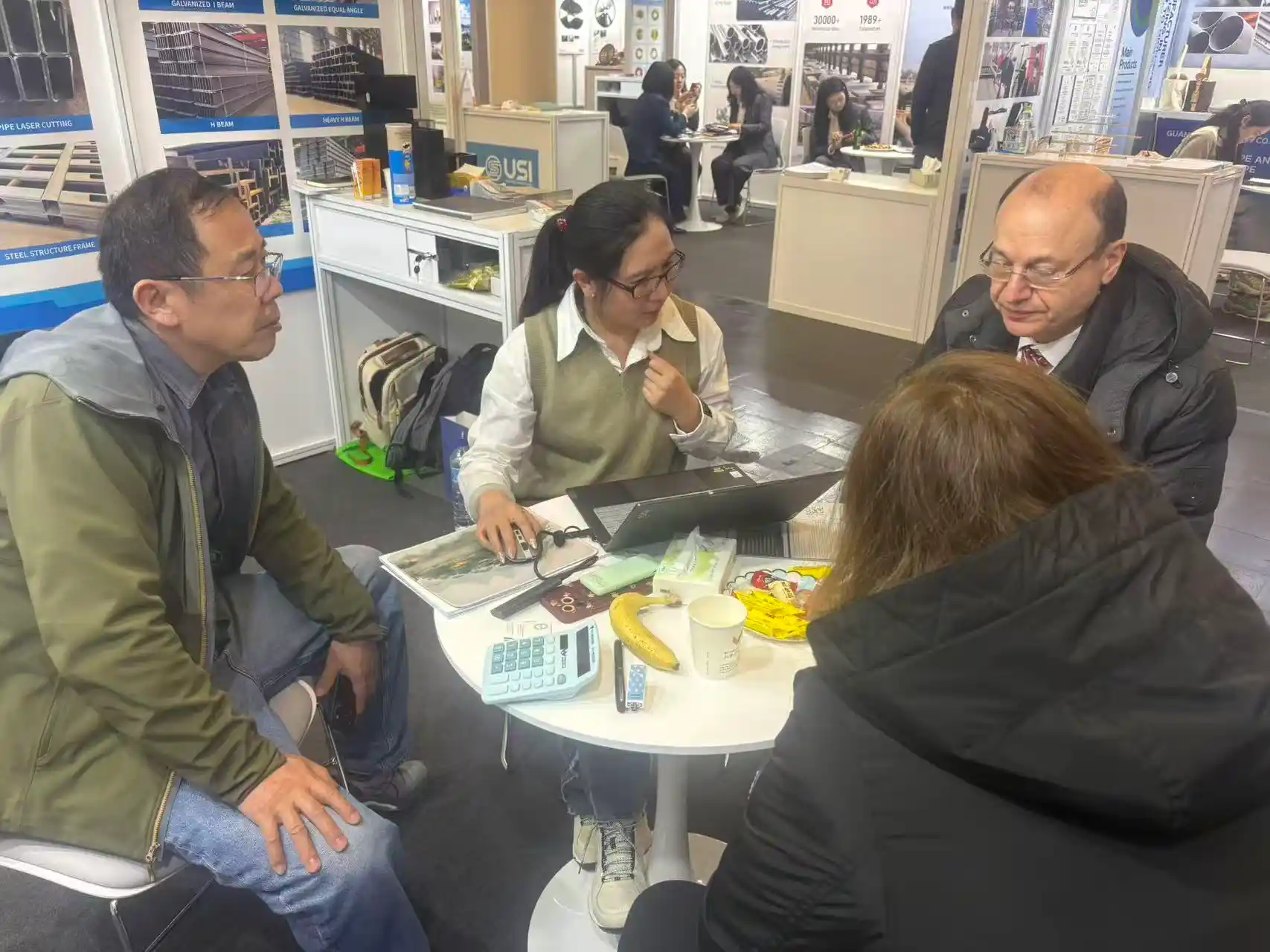 Company booth with product catalogue at a steel industry exhibition