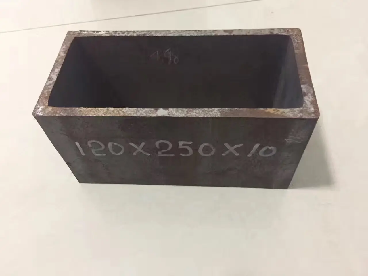 Close-up of finished steel tube samples with sharp corners