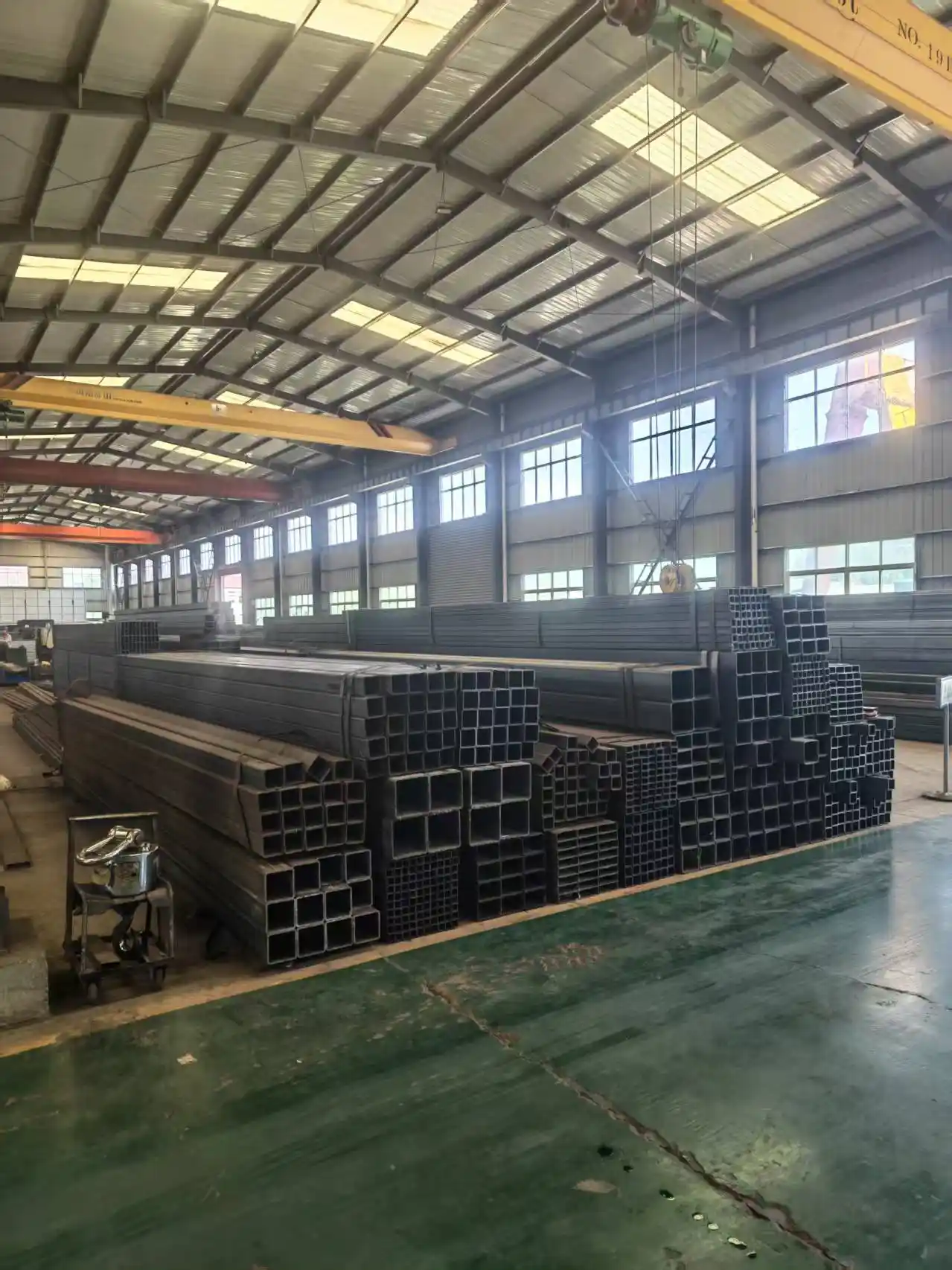 Rows of square steel tube bundles stored in the warehouse